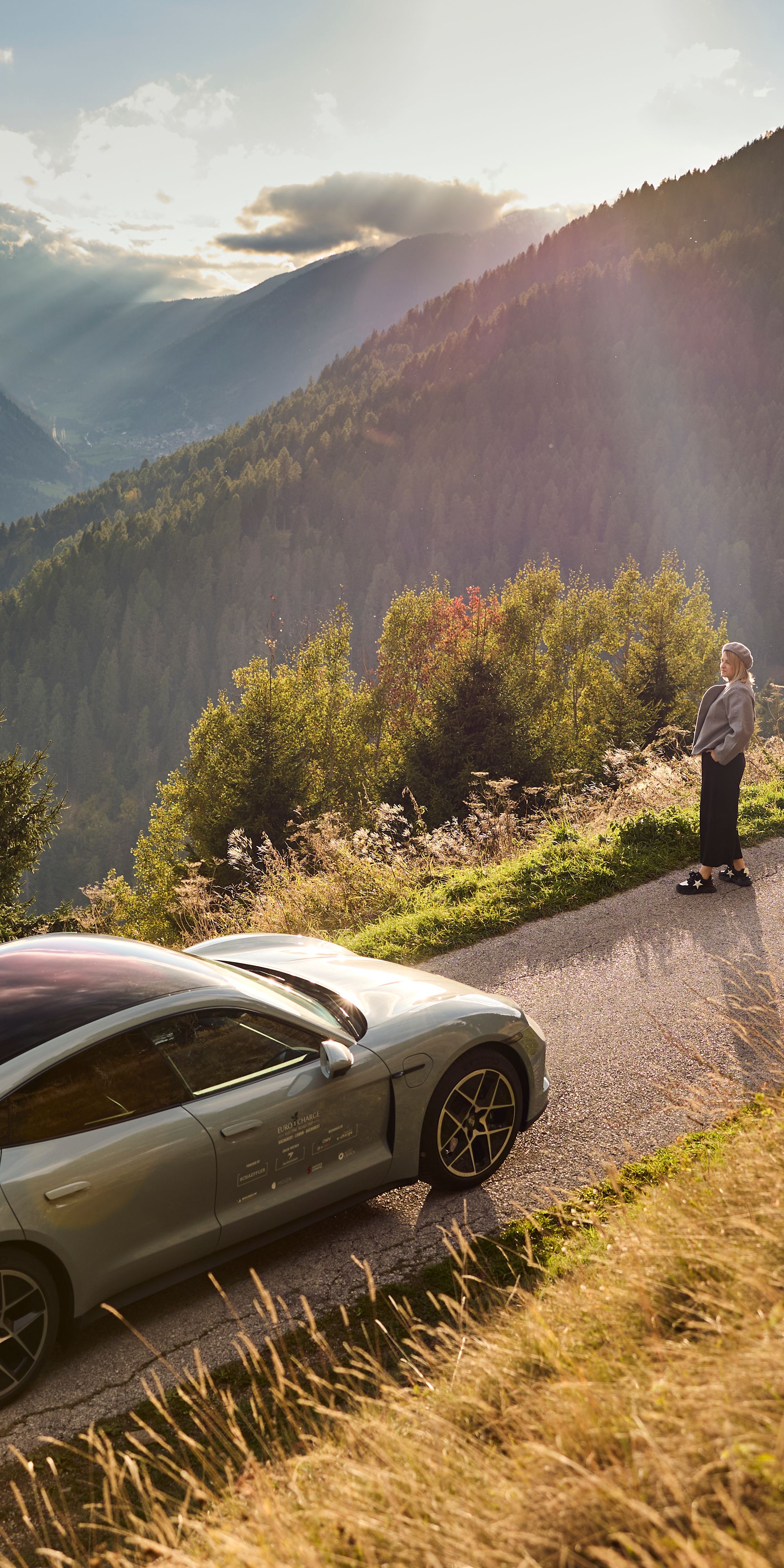 Car driving up a mountain on a road