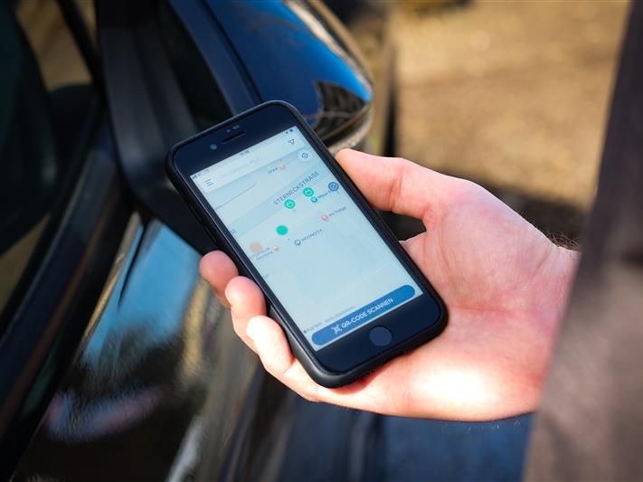 Hand holding mobile phone depicting a card