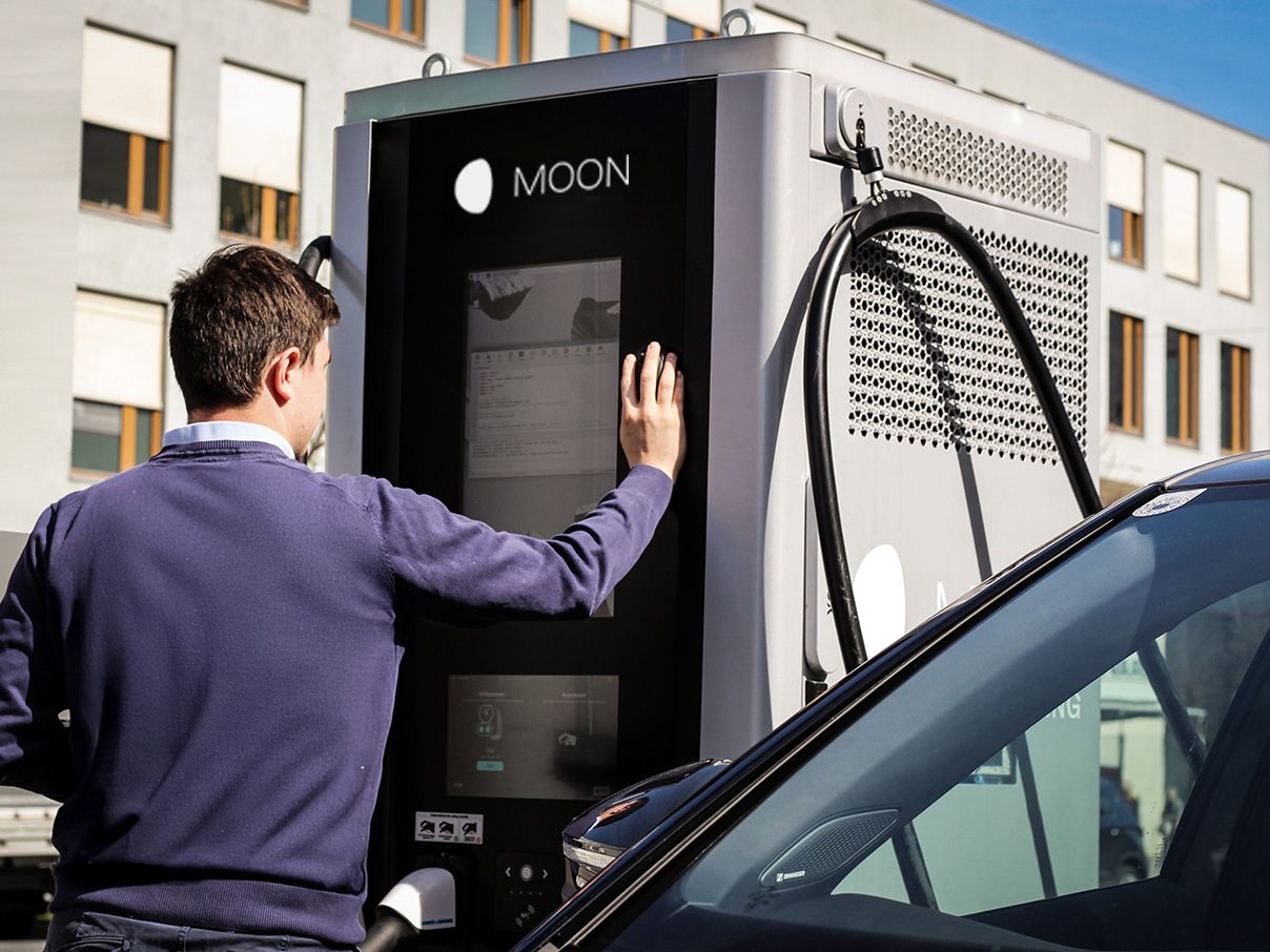 Man operating display of a charging station