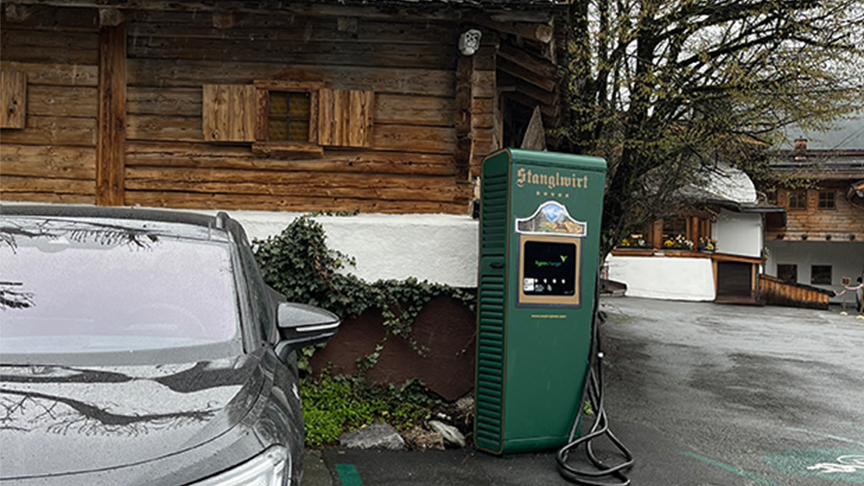 Charging station in an e-parking lot next to a car