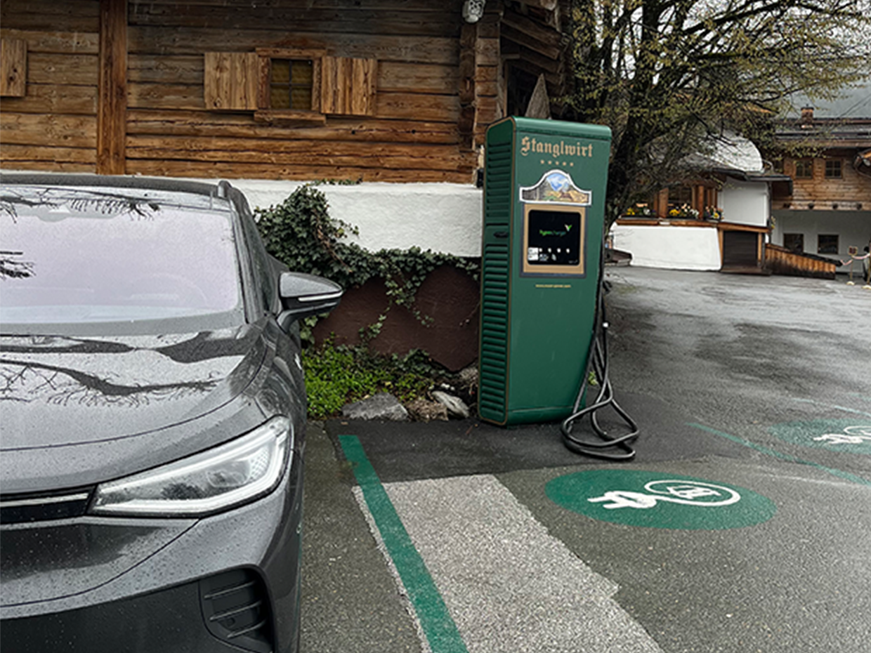 Charging station in an e-parking lot next to a car