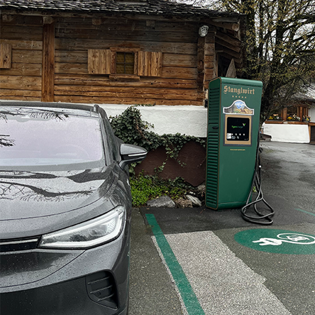 Charging station in an e-parking lot next to a car