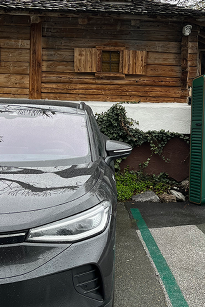 Charging station in an e-parking lot next to a car