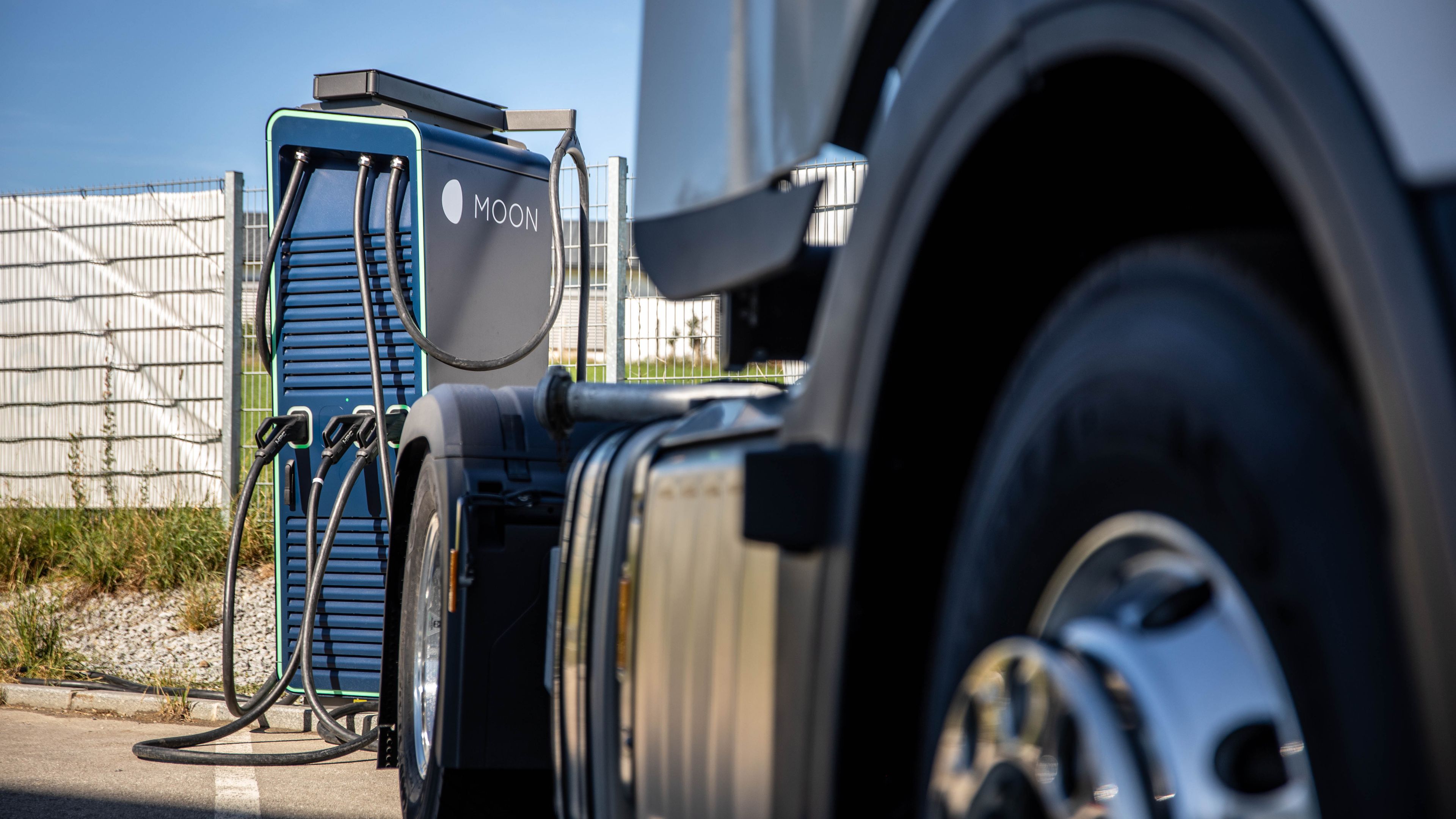 a truck stands in front of a HYC 200-400 fast charging station