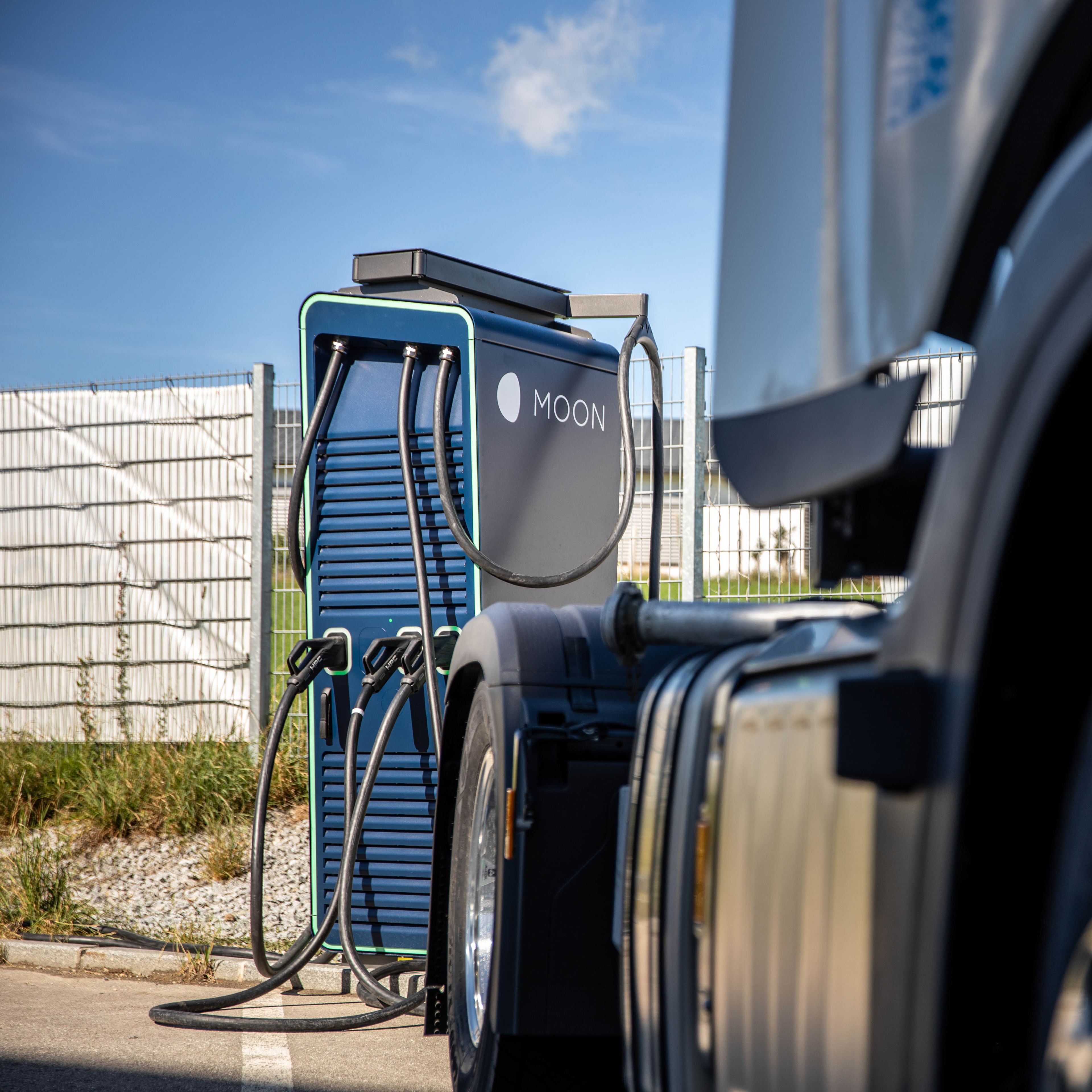 a truck stands in front of a HYC 200-400 fast charging station