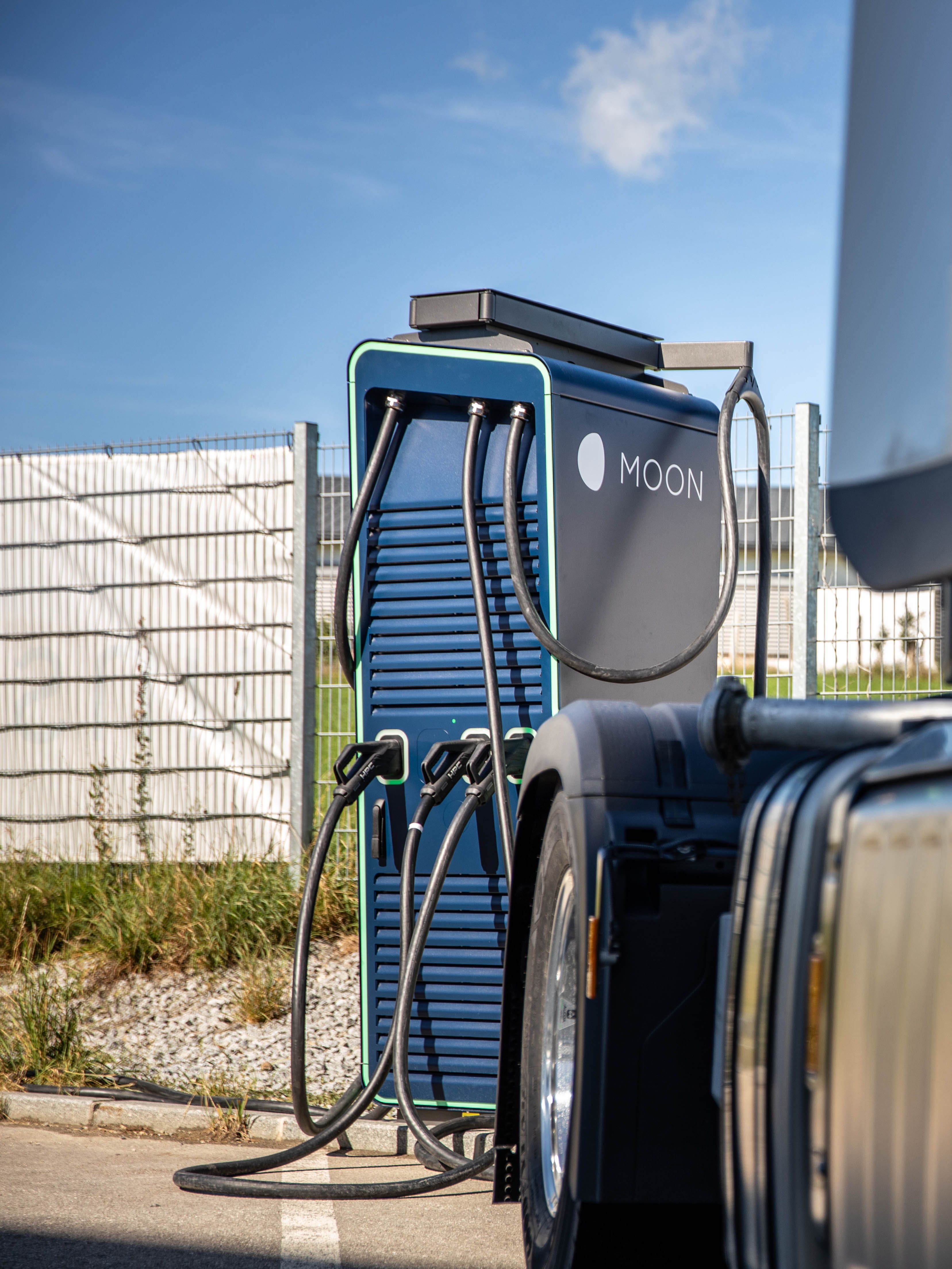 a truck stands in front of a HYC 200-400 fast charging station