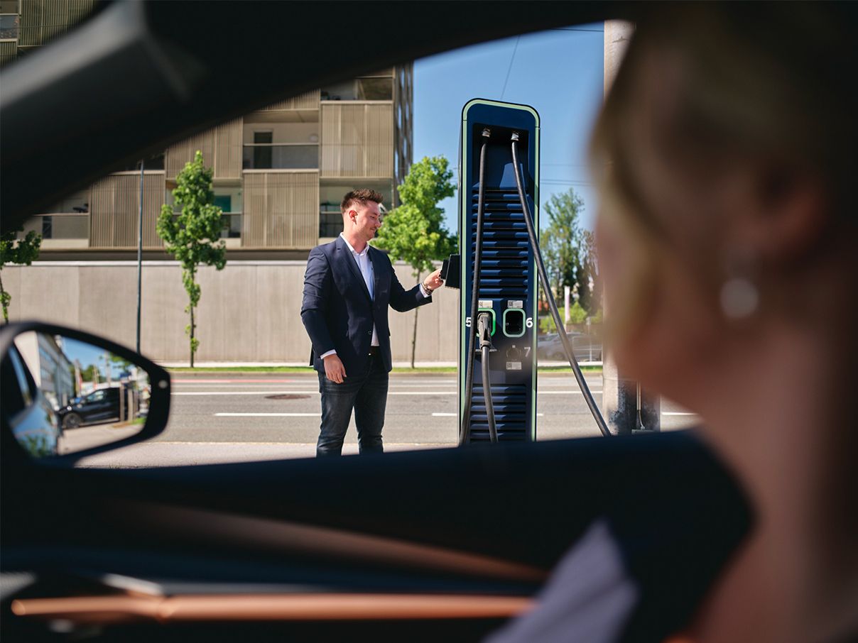 Person pays with a card at a charging station