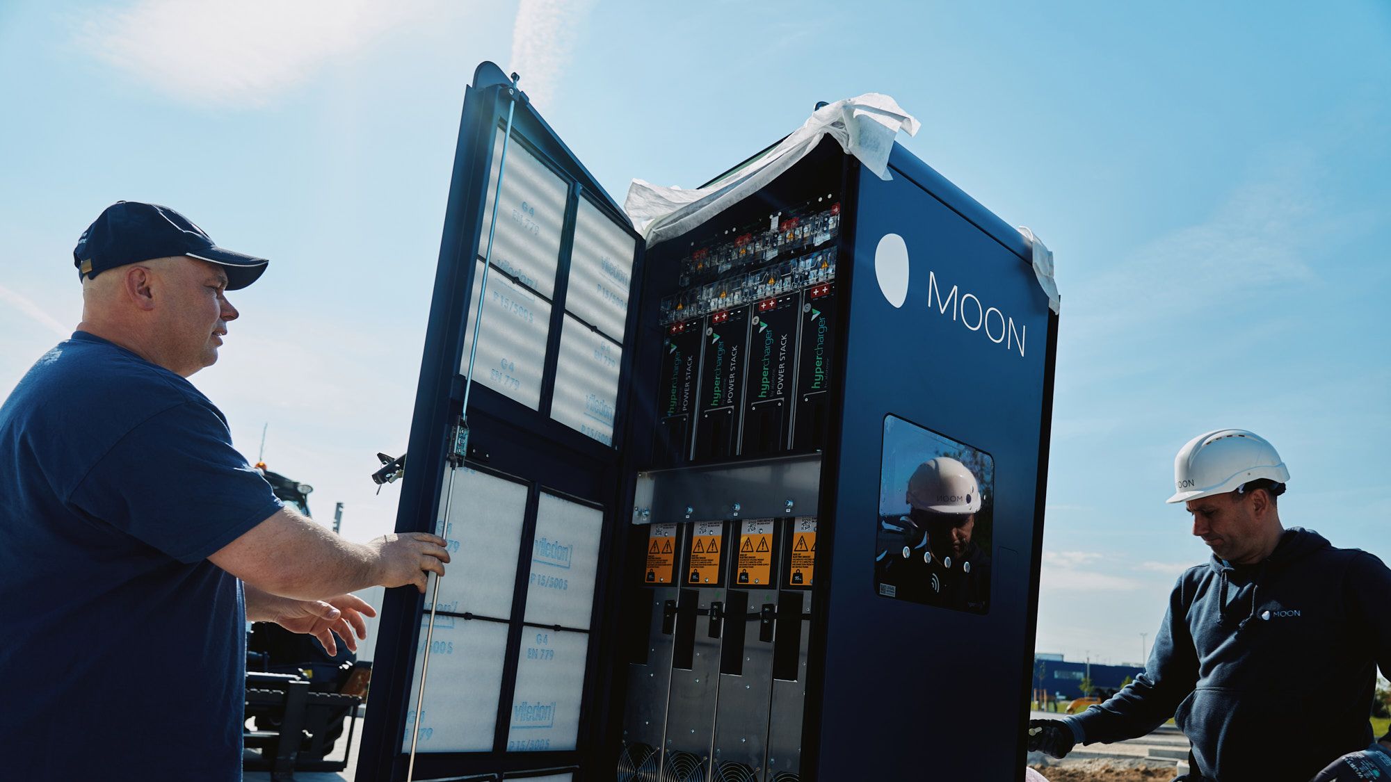 two men carry out the installation of a POWER Charger