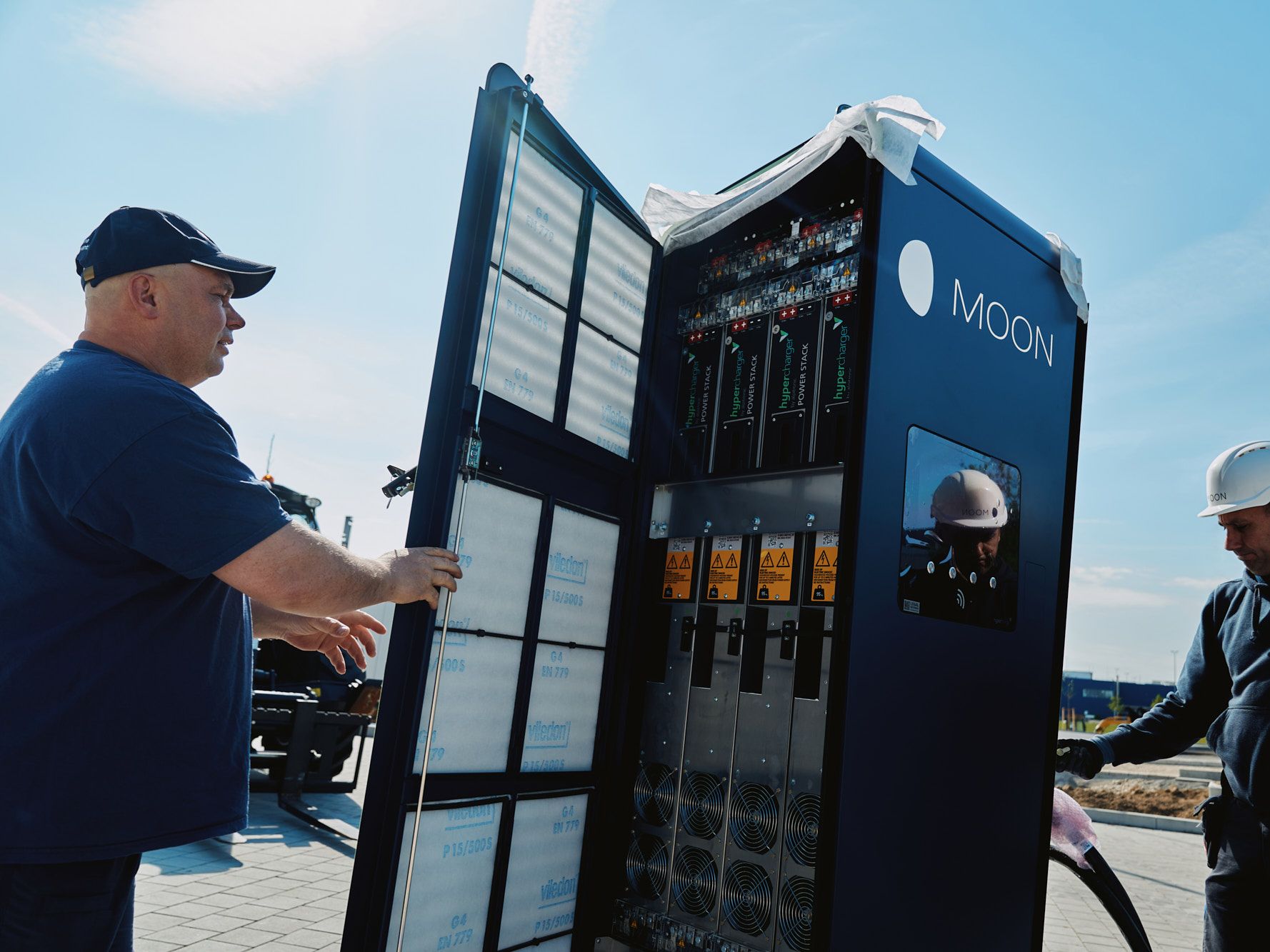 two men carry out the installation of a POWER Charger