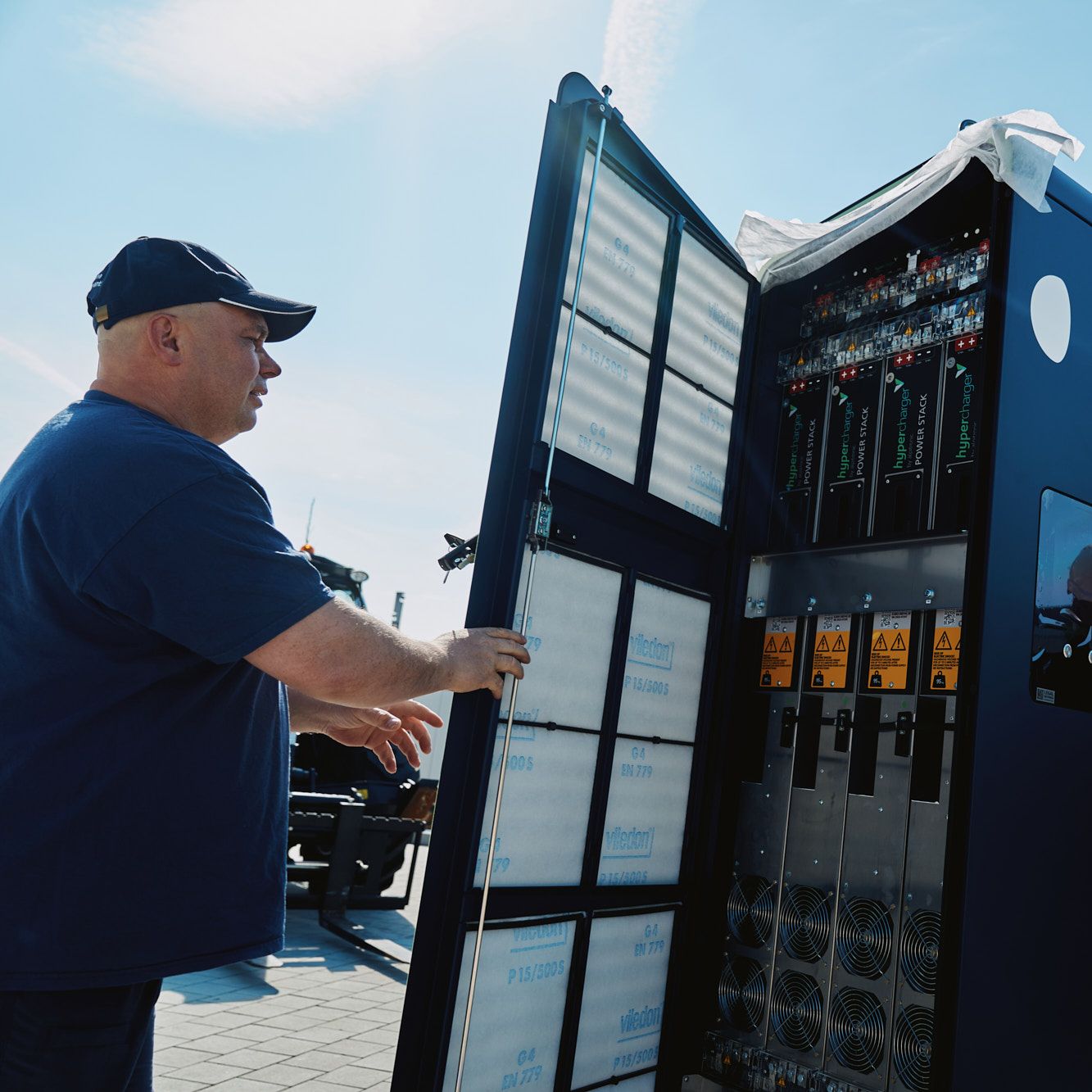two men carry out the installation of a POWER Charger