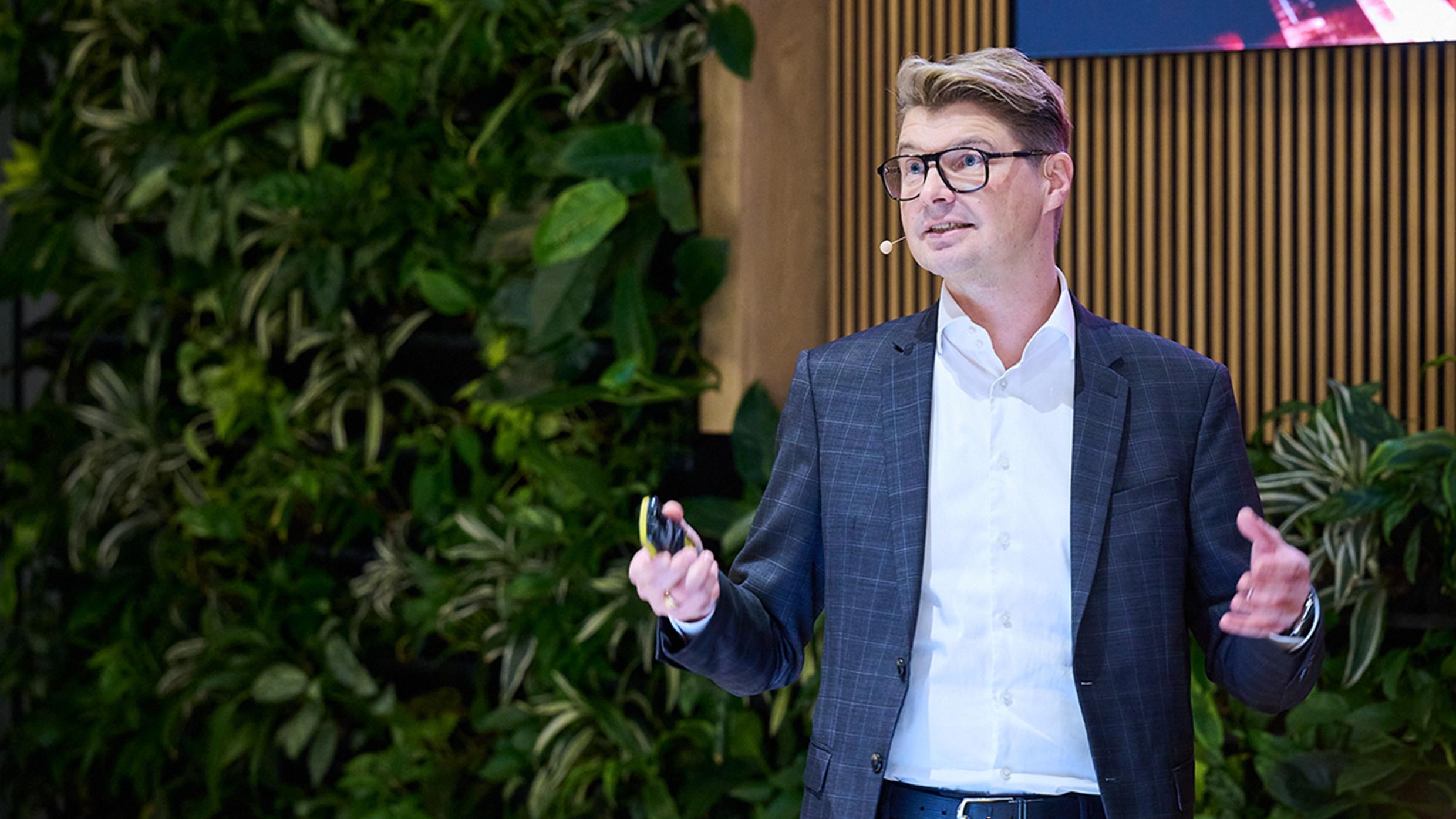 Man in front of background with plants