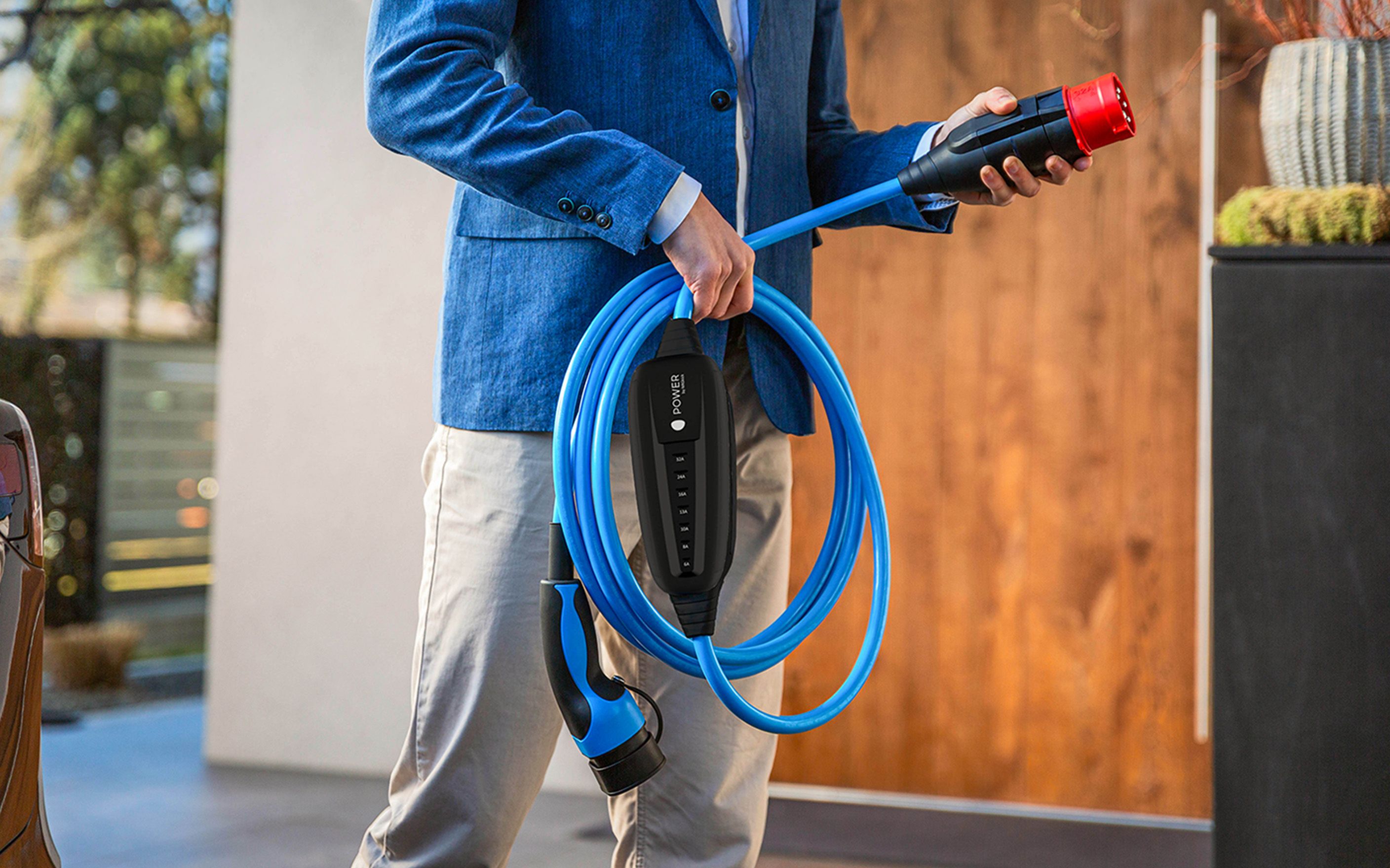 A man holds the plug of a cable in his hand