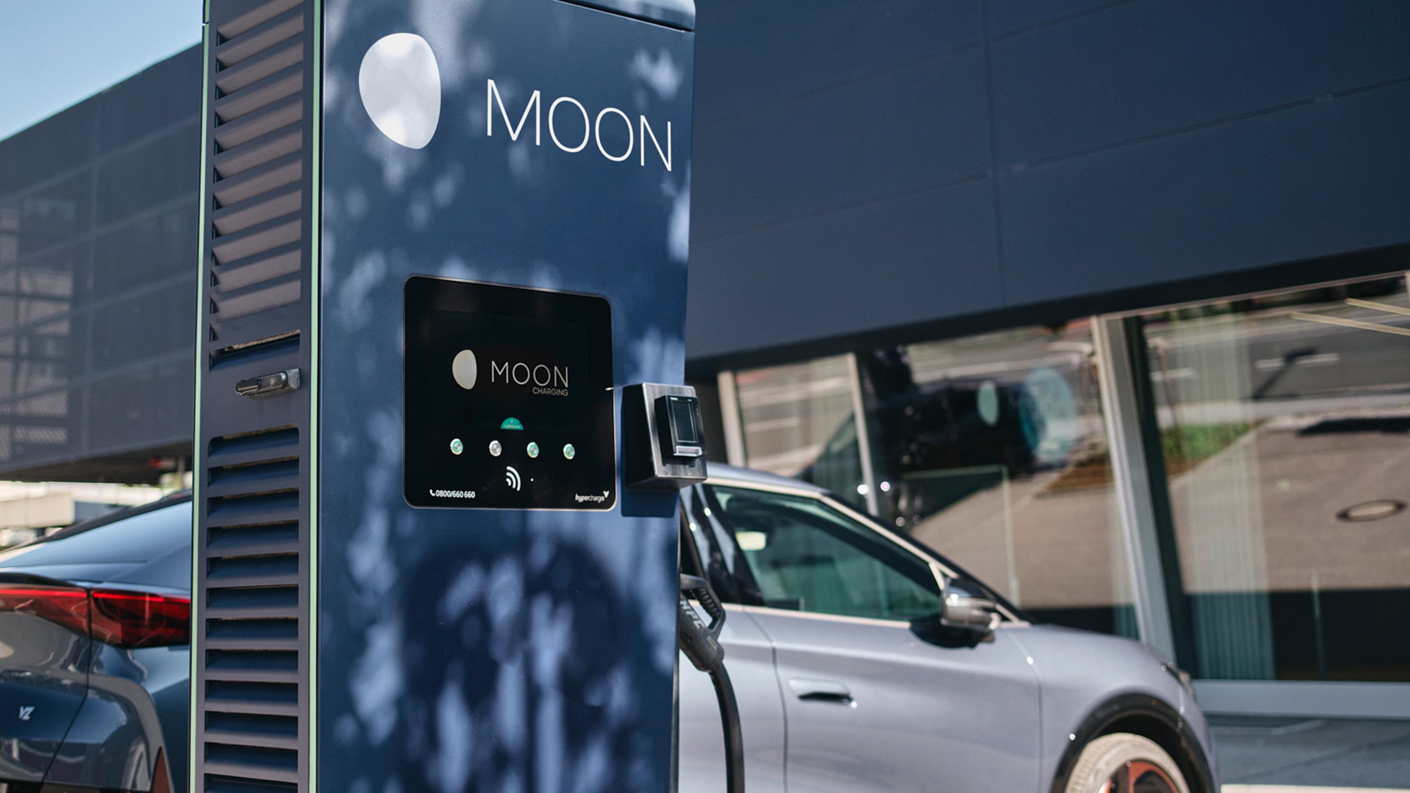 Charging station in front of a car with a display