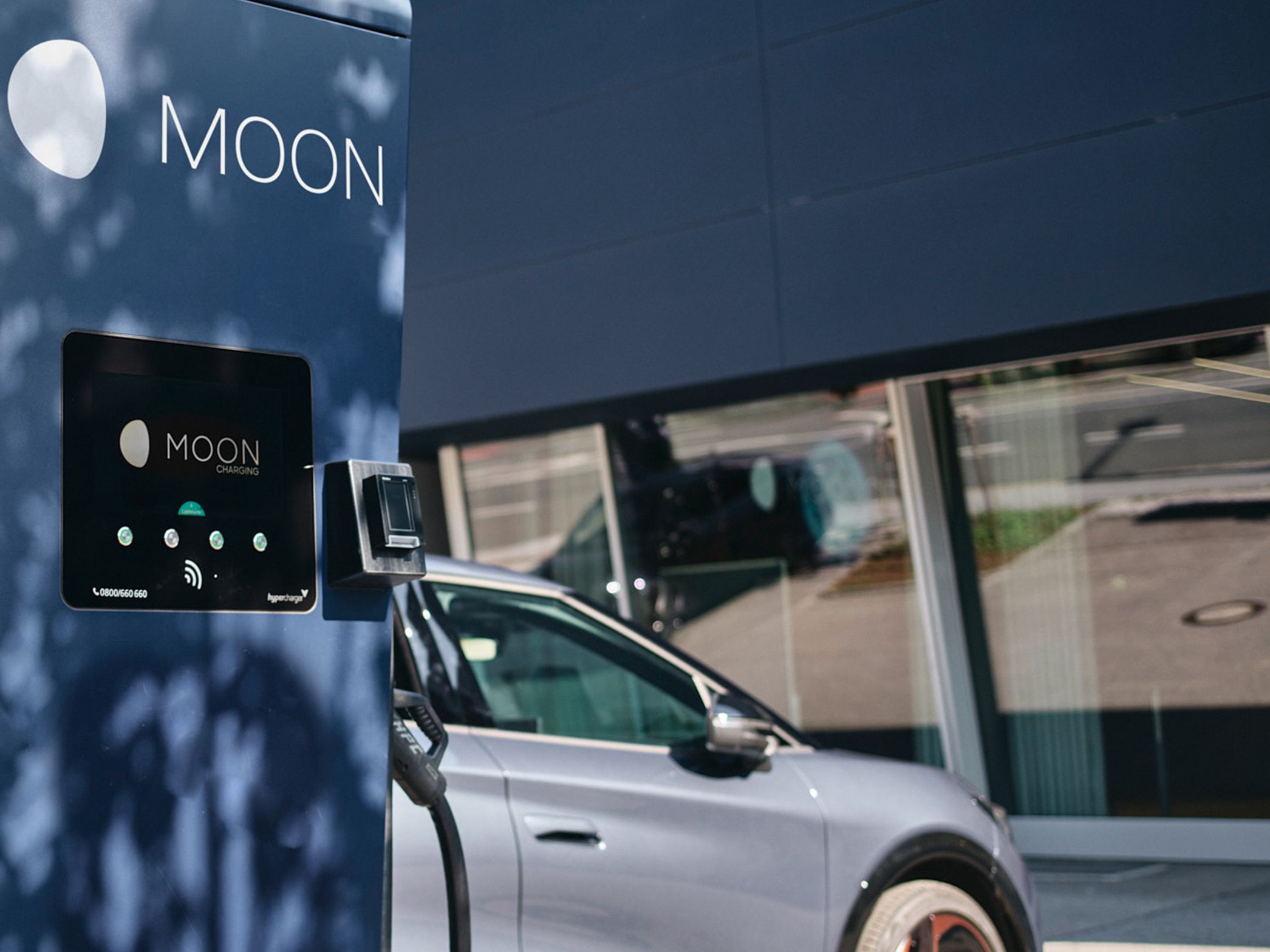 Charging station in front of a car with a display