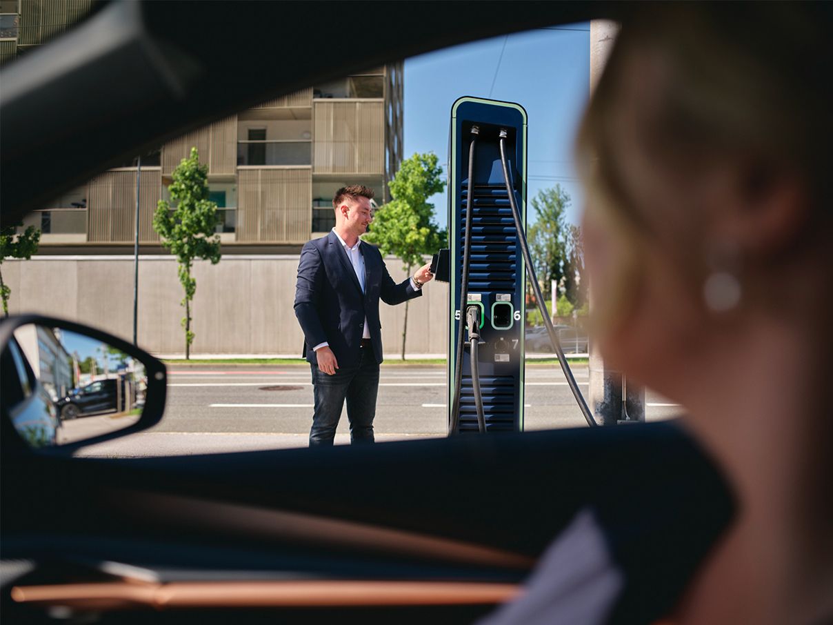 Man holds card to a charging station