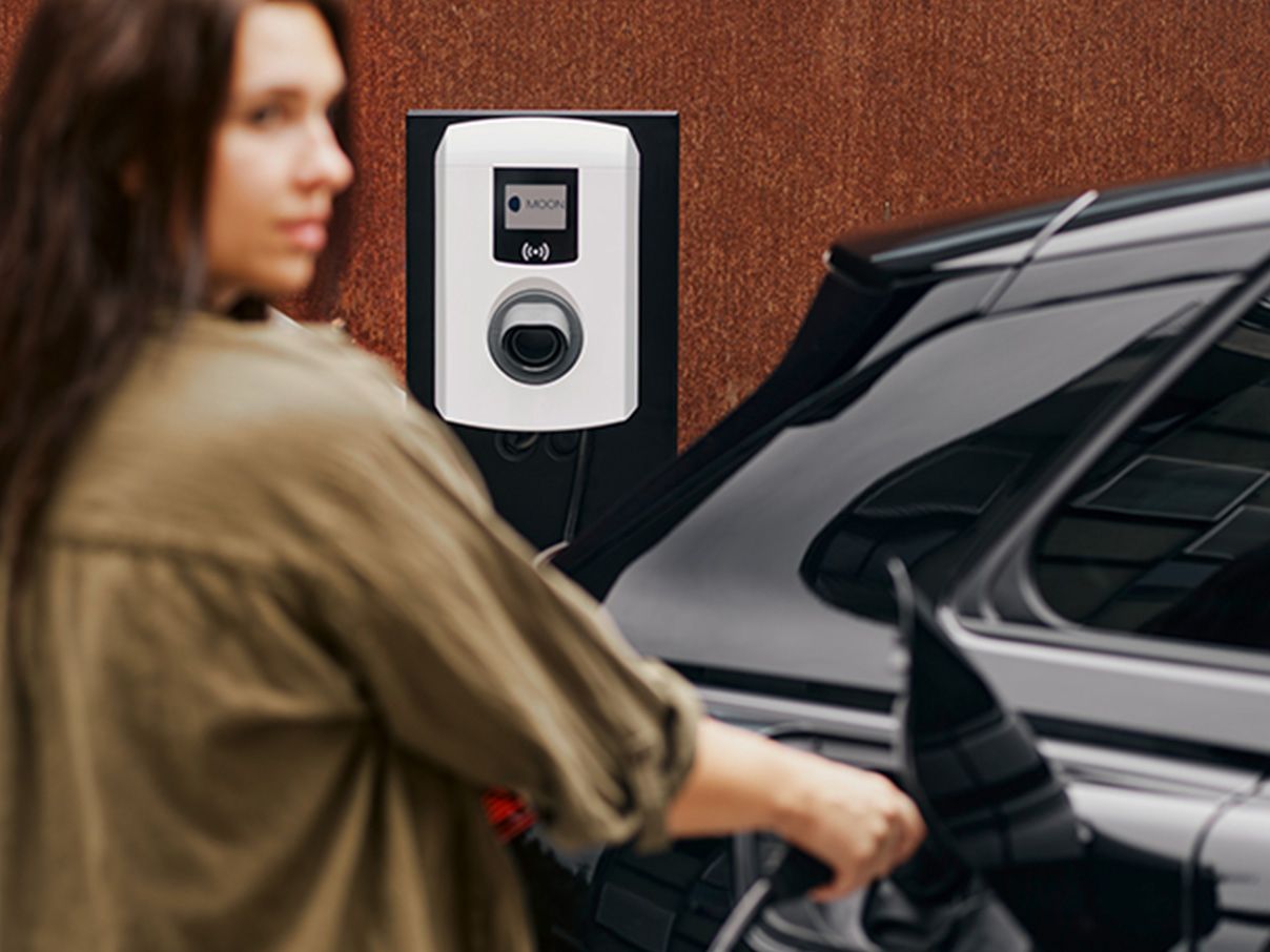 Woman sticking tap valve into a car