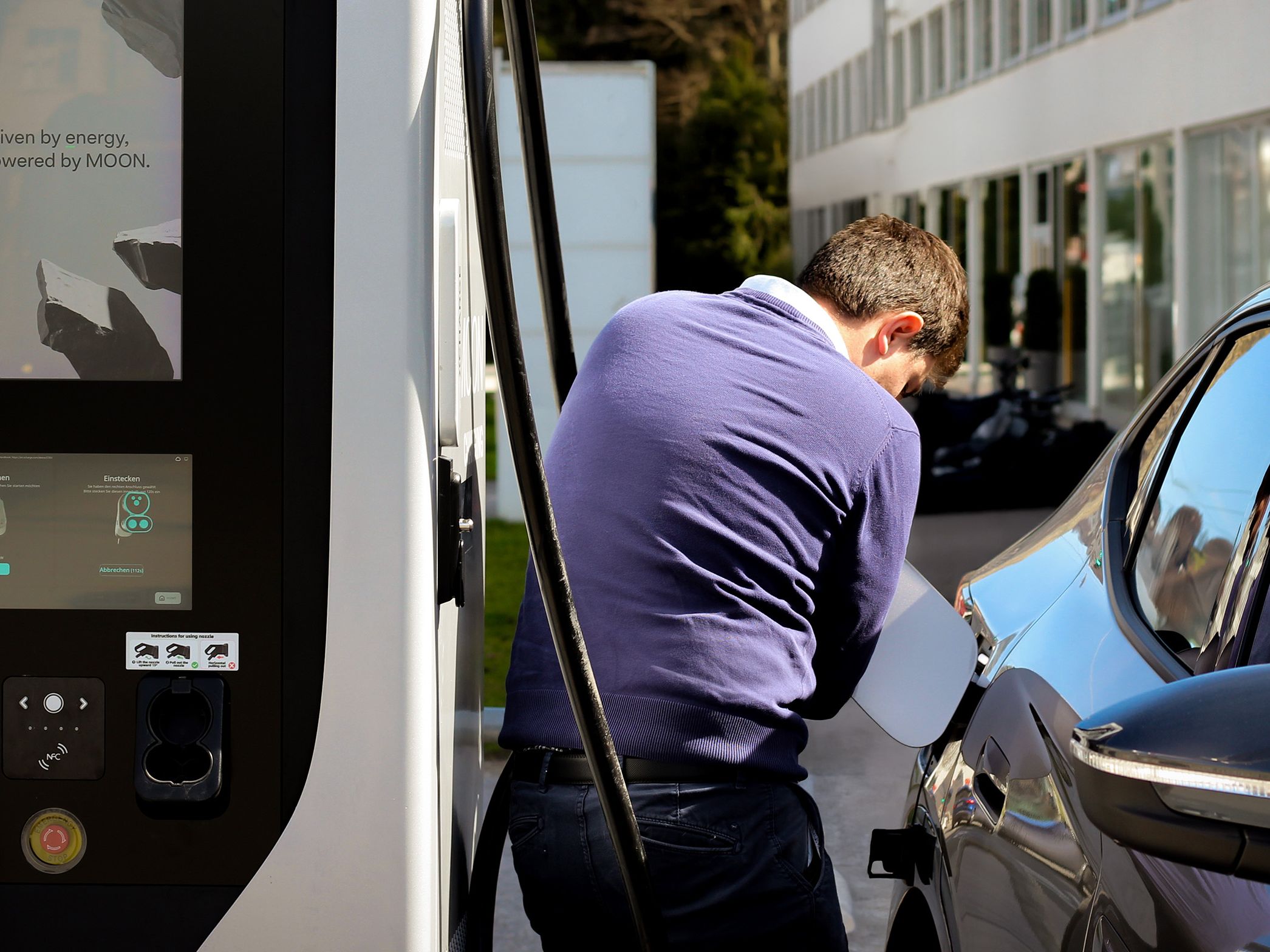 Man opens fuel cap of car